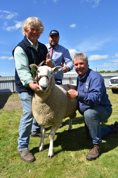 QUALITY: SAL auctioneer Mat MacDonald (centre) with Neil and Jeff Johnson, Johnos stud, and their $19,500 ram, which set a new Australian Border Leicester record.