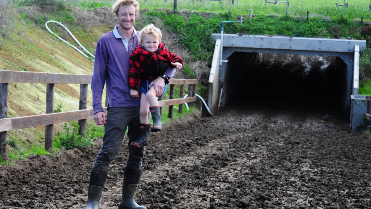 Ben Walker, with son Blue, 3, says the newly installed livestock underpass at the Mount Schank dairy he sharefarms has made an immeasurable difference to productivity. 