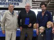SE Merino Field Days life member Brian Ashby, Adelaide, presents Wayne, Matt and Digby and Darcy Lehmann, Flairdale stud, Cookes Plains with a family service award for participating in all 60 field days, initially as Flairville and Pollville. Picture by Catherine Miller