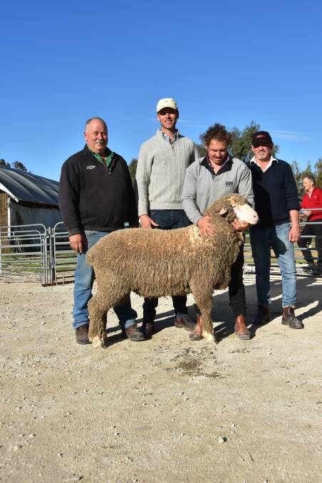 Kevin and Jack Beaton, Kevlyn Poll Merinos, Coojar, Vic, with the lot 120 ram which they bought for $5400. It is being held by Devon Ridgway with David Ridgway looking on. Picture by Catherine Miller