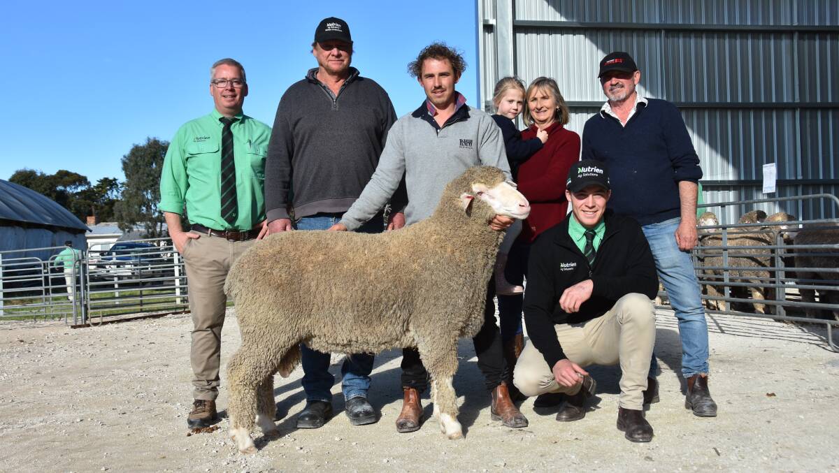 Nutrien auctioneer Gordon Wood, top price buyer Glen Farr, Loxton, Devon Ridgway holding the $10,000 ram, Karen Ridgway holding granddaughter Layla Obst, David Ridgway and at front Nutrien Bordertown's Jack Guy. Picture by Catherine Miller