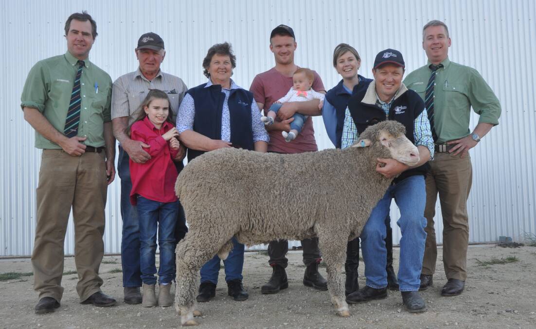 TOP PICK: Landmark stud stock auctioneers Richard Miller and Gordon Wood (right) with David, Jessica, Bev, Peta and Stephen Kellock (holding ram), Kelvale stud, Keith, and buyer of the $6200 top price ram Tom Davey (centre), Port Neill, holding daughter Indie. The Daveys have been using Kelvale bloodlines for more than 30 years.