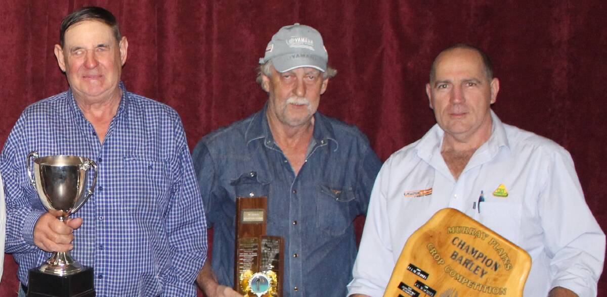 BEST BARLEY: Colin Wachtel and Robert Wagenknecht, Palmer, with their champion and quality barley trophies and Platinum Ag Services' Steve Hein. Photos: ZOE STARKEY