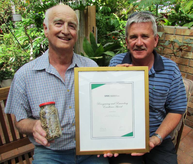 AWARD WIN: Graham Hayes receiving his GRDC Recognising and Rewarding Excellence Award from GRDC Southern Regional Panel member Bill Long, who said Graham had been at the forefront of snail research the past 20 years.