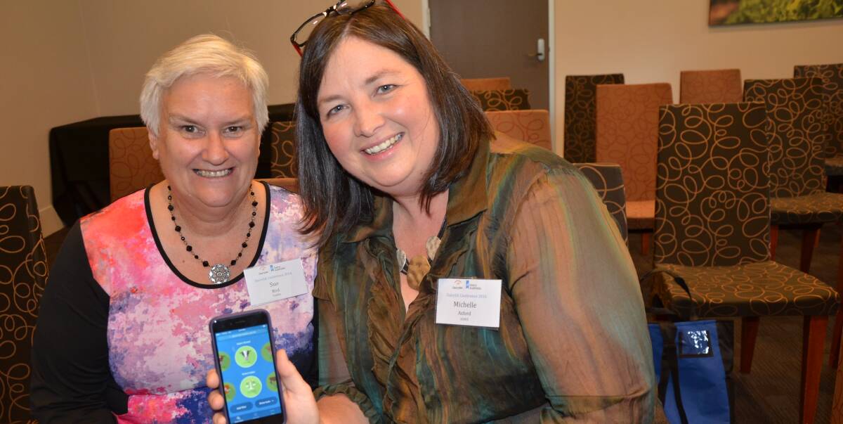 HIGH TECH: Michelle Axford (right), ADHIS, shows tafeSA's Sue Bird the Good Bulls app, which allows people to select up to 50 filters on bulls, then send a shortlist to their semen provider. It also sends a reminder.