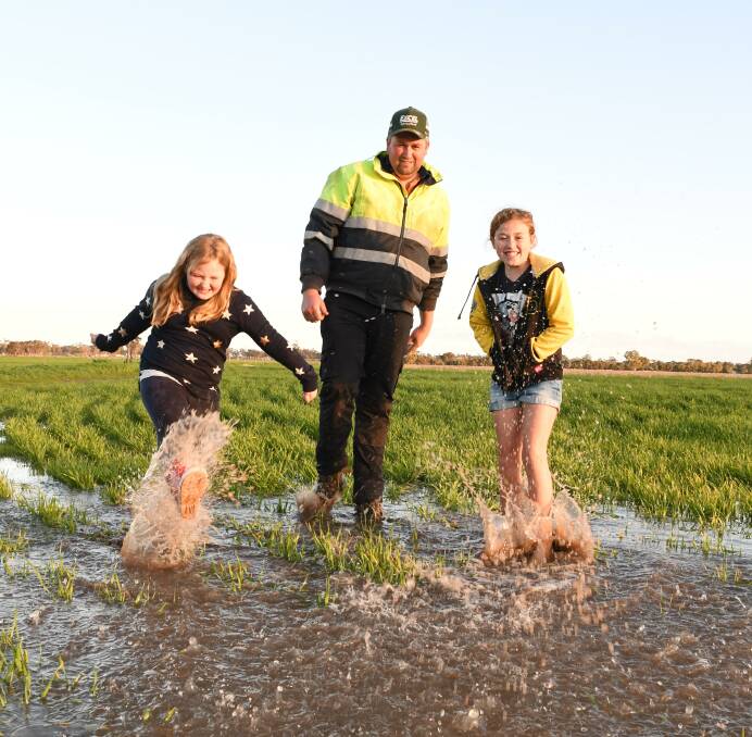 The season is set up "about as well as it could be" for Cannawigara's Josh Hunt (centre), who was out doing a crop and puddle inspection with daughters Asha, 6, and Georgia, 9.
