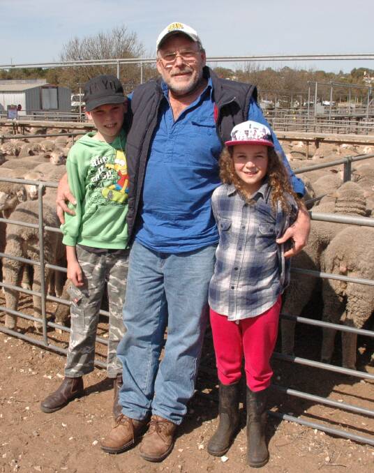 MARKET WATCH: Trev Giles (centre), Langhorne Creek, with grandchildren Jack and Eva Turner, was looking for lambs to put in his feedlot.