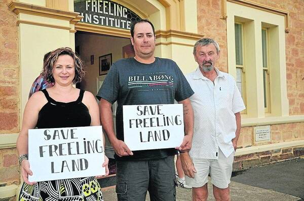 LAND PLEA: Letting their feelings be known are Freeling residents Ali and Troy Hutchinson and Andrew Schuster.