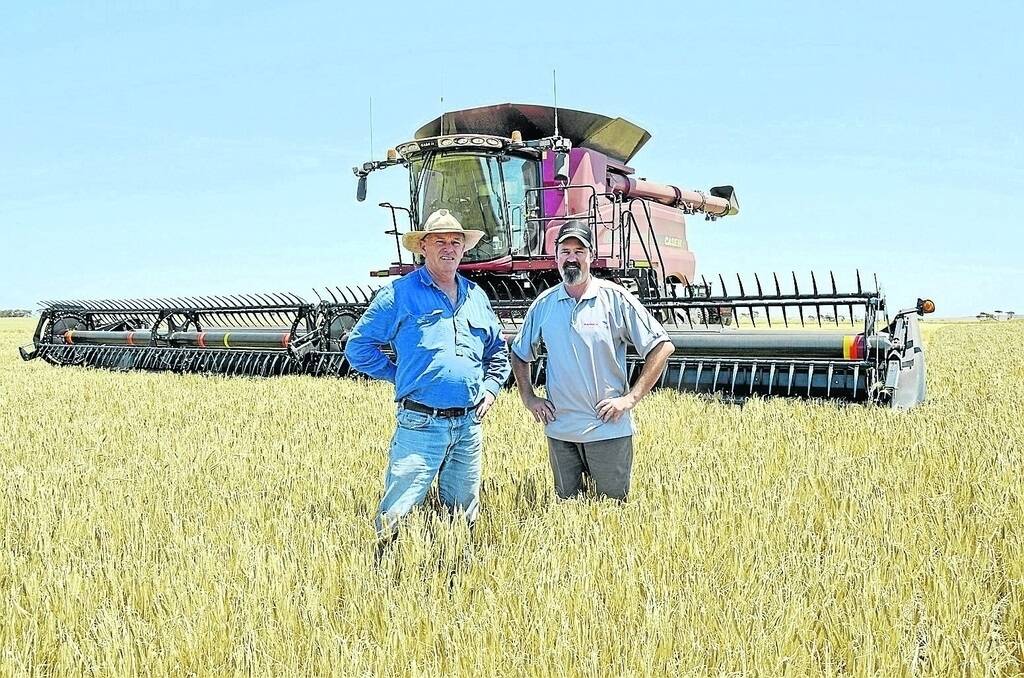 Ungarra farmer Kym Penalurick and Ramsey Bros director Hamish Ward out in the paddock with Mr Penalurick’s new purchase – a Case IH 8240 Axial-Flow header.
