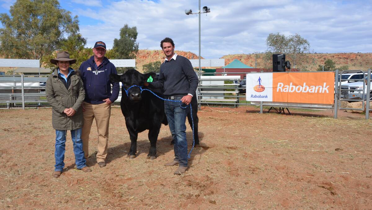 SALE TOPPER: Belinda and Brad Seymour, Haasts Bluff, via Alice Springs, with Trent Walker, Keringa, Culburra, and the $9500 sale topper bull.
